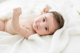 Close-up of a newborn's hands resting in a parent's palm